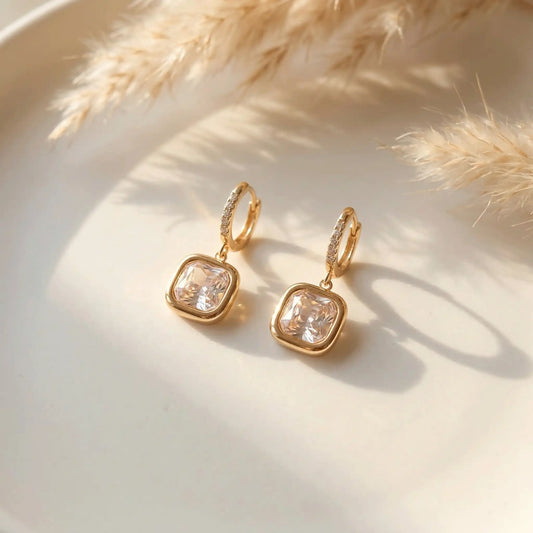 Cushion Cut Drop Earrings with clear gemstones on a light background
