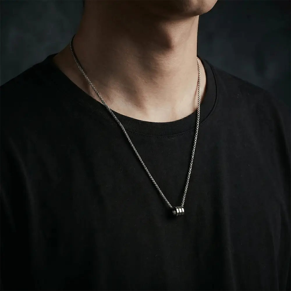 Man wearing sleek silver cylinder pendant necklace with modern stainless steel chain by K-A Trends