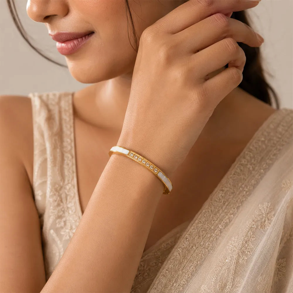 Indian model wearing Diamond Edge anti tarnish brass bracelet with crystal accents and elegant white inlay detailing.