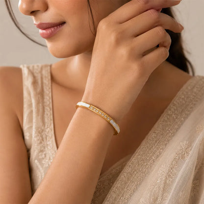Indian model wearing Diamond Edge anti tarnish brass bracelet with crystal accents and elegant white inlay detailing.