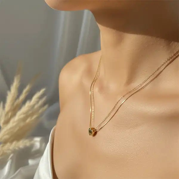 Gold double chain heart pendant worn by model, anti-tarnish necklace for daily wear, elegant minimalist jewellery