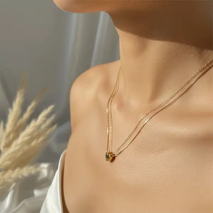Gold double chain heart pendant worn by model, anti-tarnish necklace for daily wear, elegant minimalist jewellery