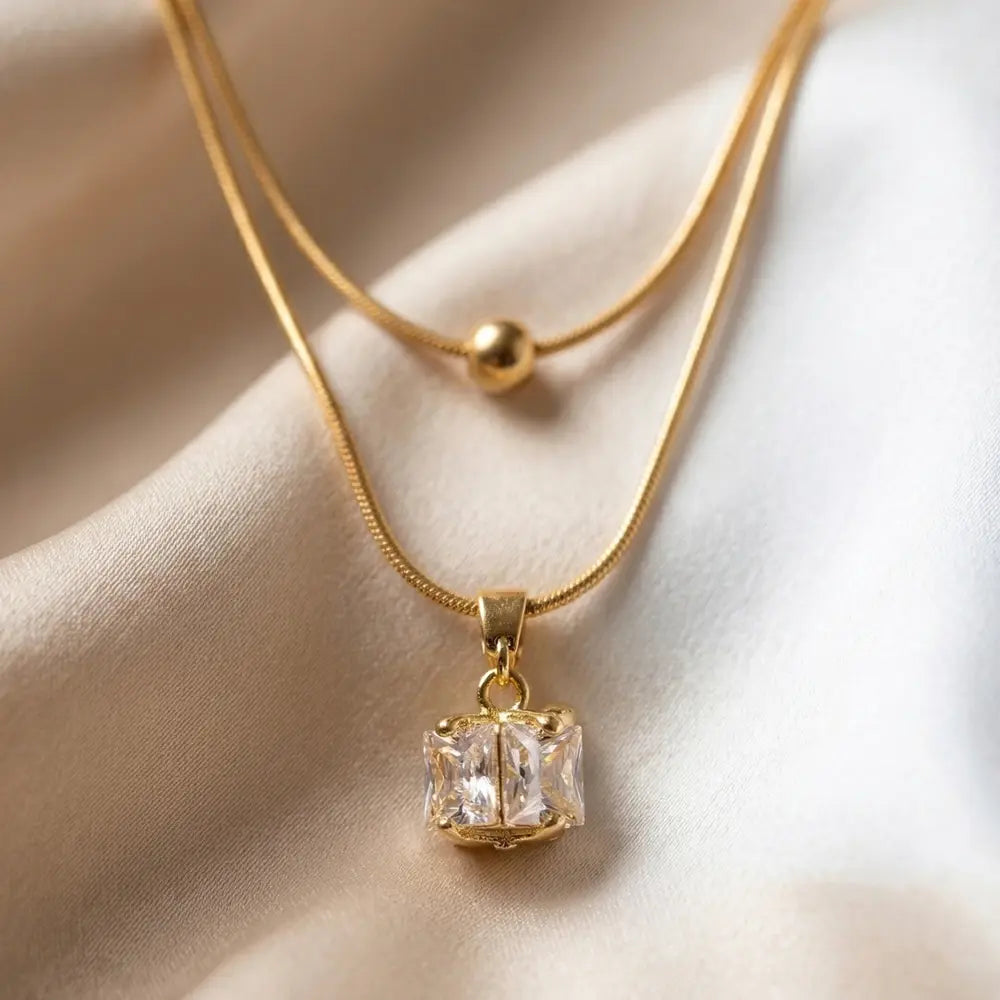 Double Cube Pendant-Anti-Tarnish on a beige fabric background