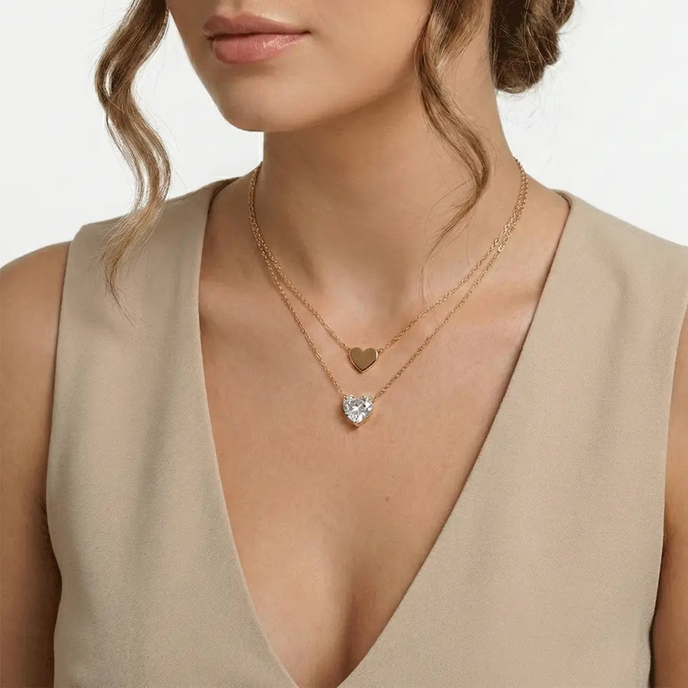 Model wearing double layer heart pendant necklace in gold finish, anti tarnish everyday necklace for women