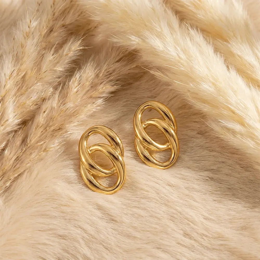 K-A Trends anti tarnish gold double loop stud earrings on soft beige fur background premium minimalist jewellery flatlay
