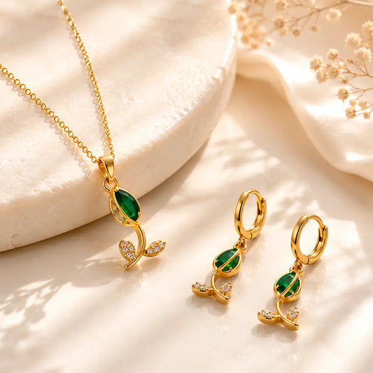 Emerald Petal anti tarnish pendant set featuring a green marquise-cut stone pendant and matching hoop earrings with crystal leaf accents.