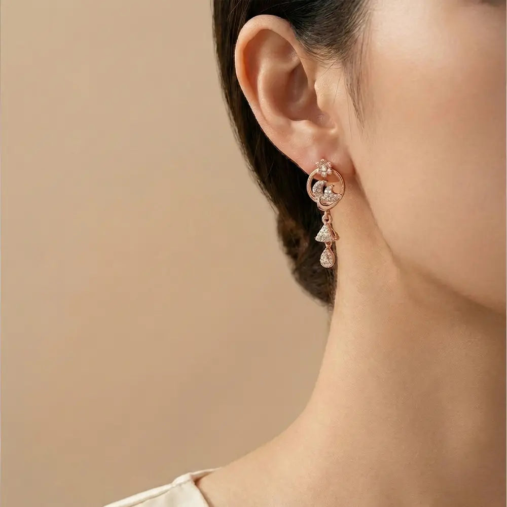 Model wearing floral spark AD drop earrings in rose gold finish, anti tarnish elegant earrings for women