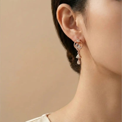 Model wearing floral spark AD drop earrings in rose gold finish, anti tarnish elegant earrings for women