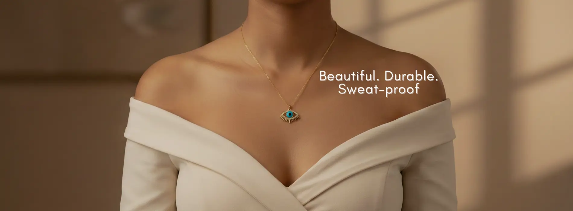 Necklace with a pendant on a person wearing a white off-shoulder top, with text 'Beautiful. Durable. Sweat-proof