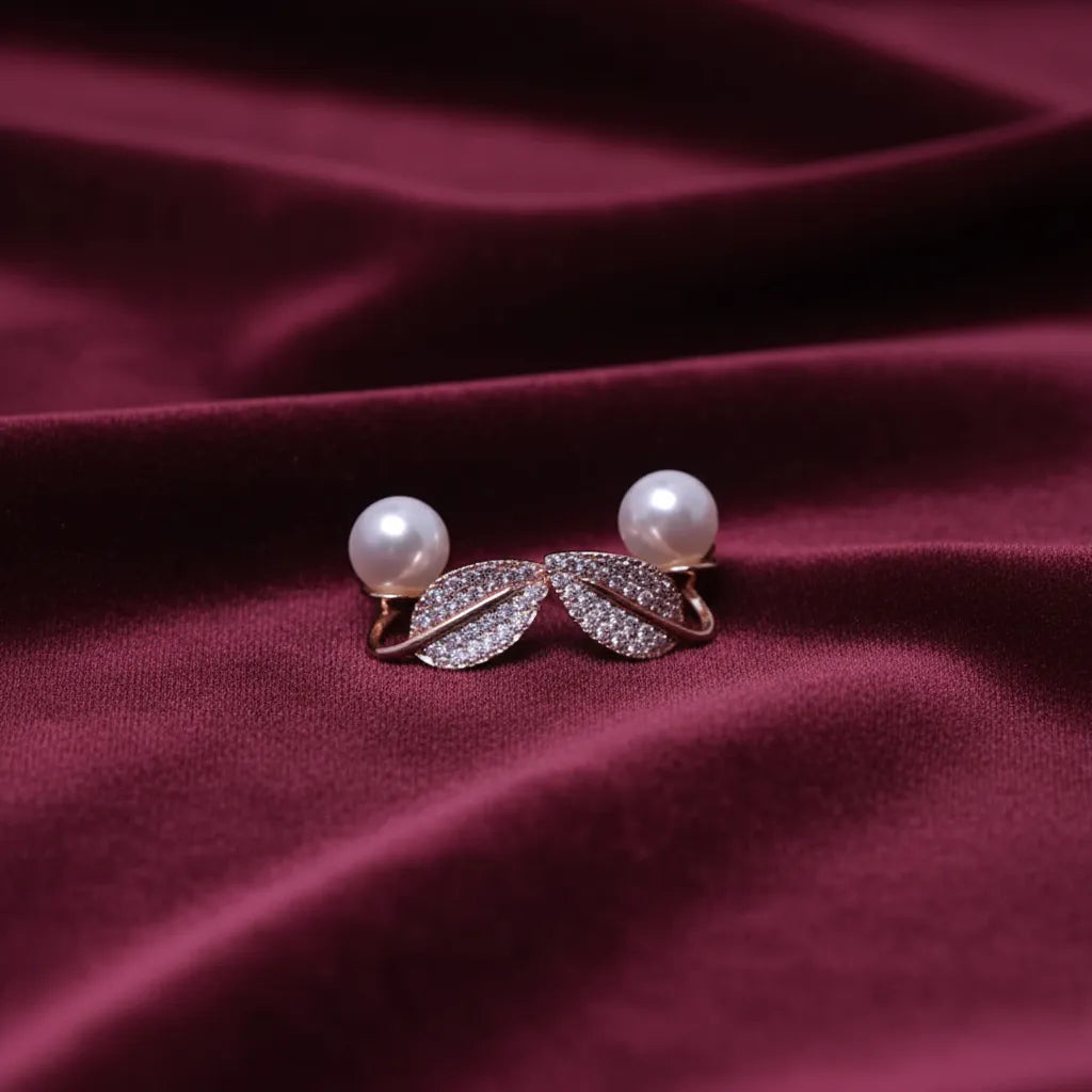 These anti-tarnish earrings have shiny leaf tops and smooth pearls that add a soft glow.