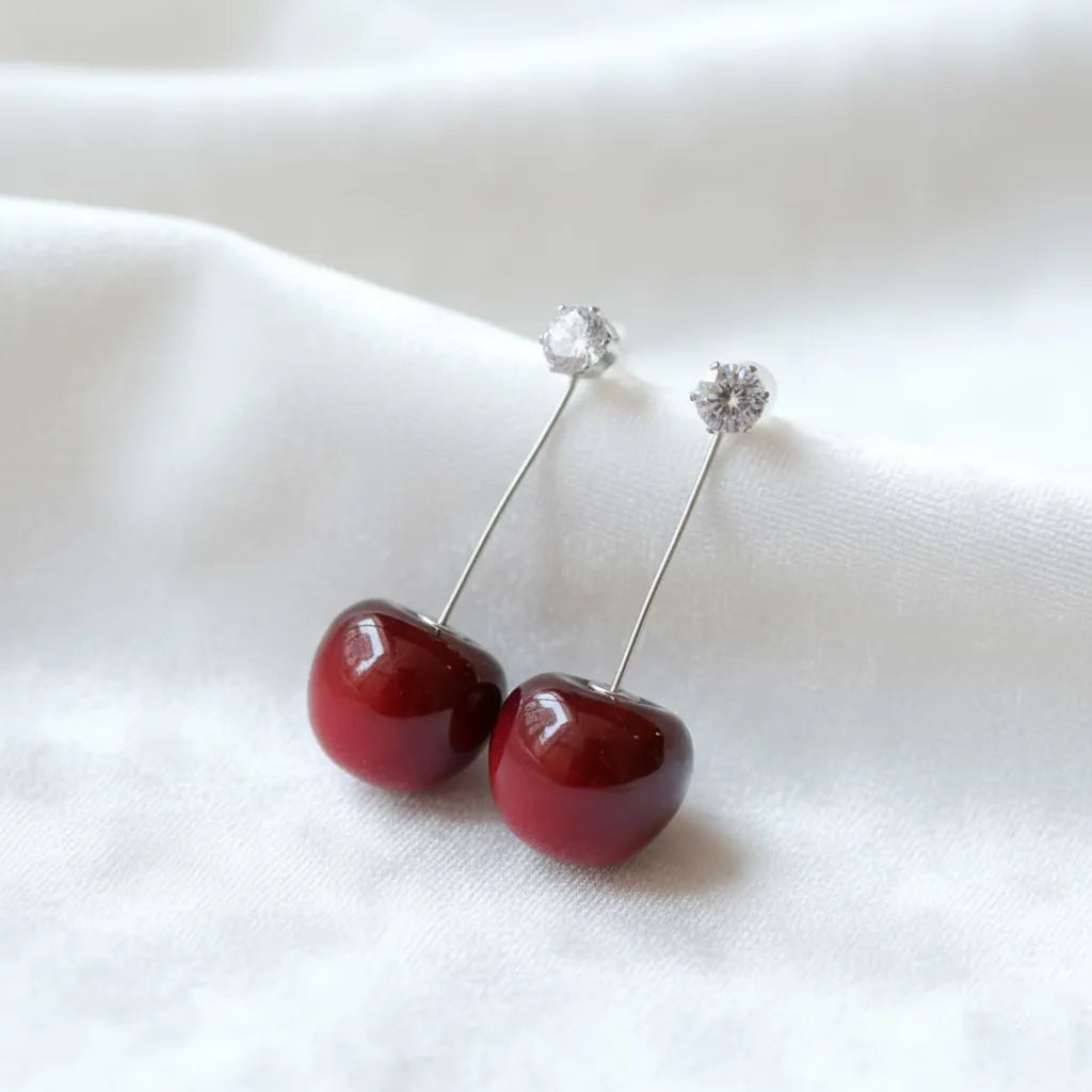 Cherry-red earrings makes a bold statement with their vibrant design, adding a fresh touch to any outfit.