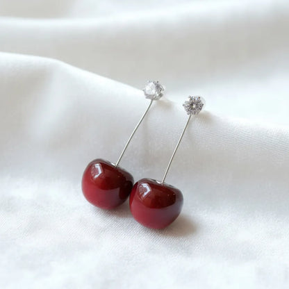 Cherry-red earrings makes a bold statement with their vibrant design, adding a fresh touch to any outfit.