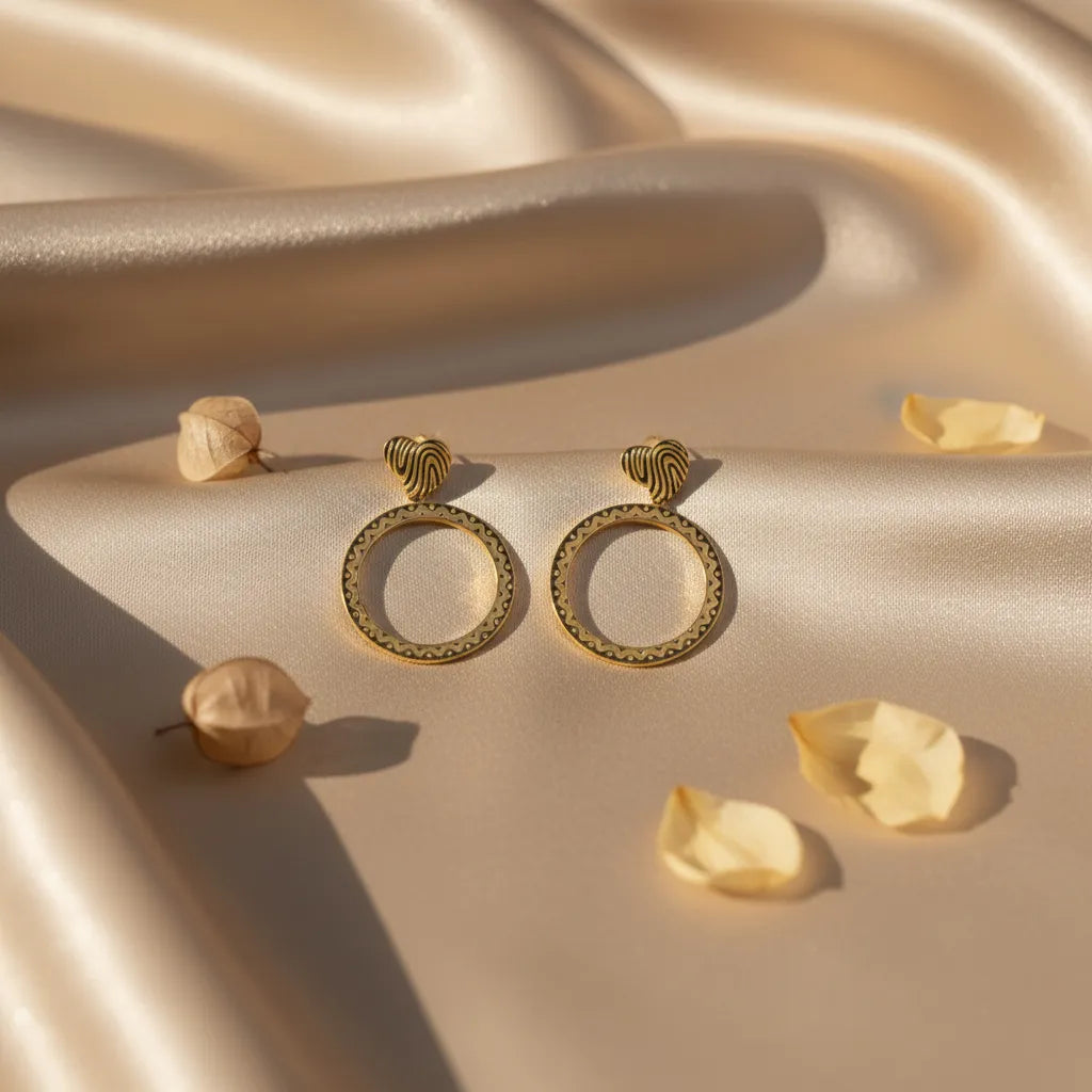 Golden Aura Hoops glow with a smooth, radiant finish.