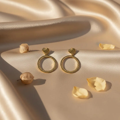 Golden Aura Hoops glow with a smooth, radiant finish.