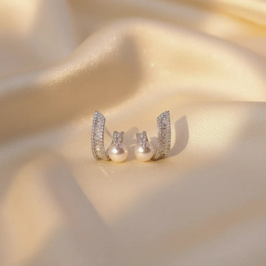 These anti-tarnish earrings combine a swirl of sparkling stones with a classic pearl design