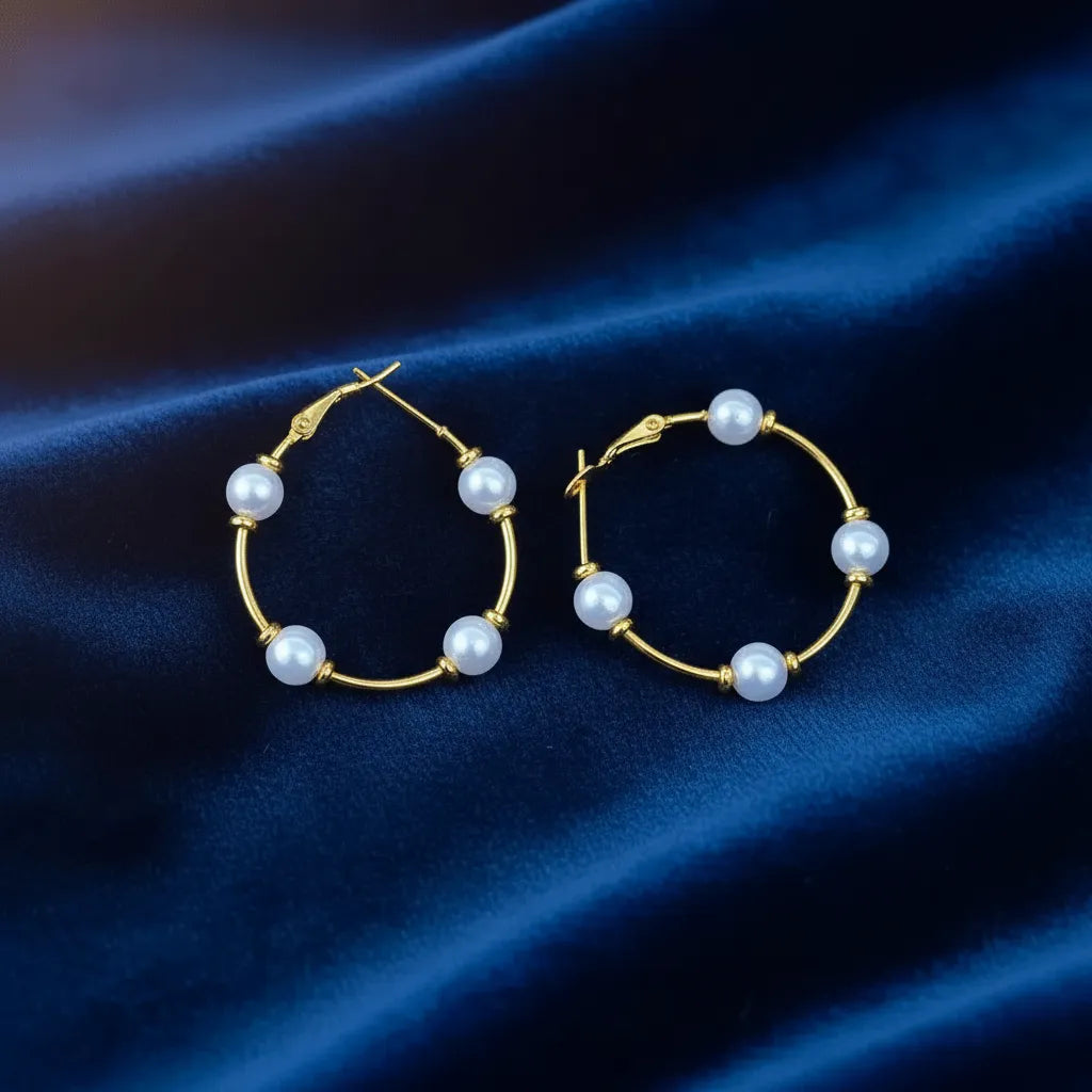 These Pearl Charm Hoops feature a beautiful mix of gold metal and glossy pearls, giving them a stylish look.