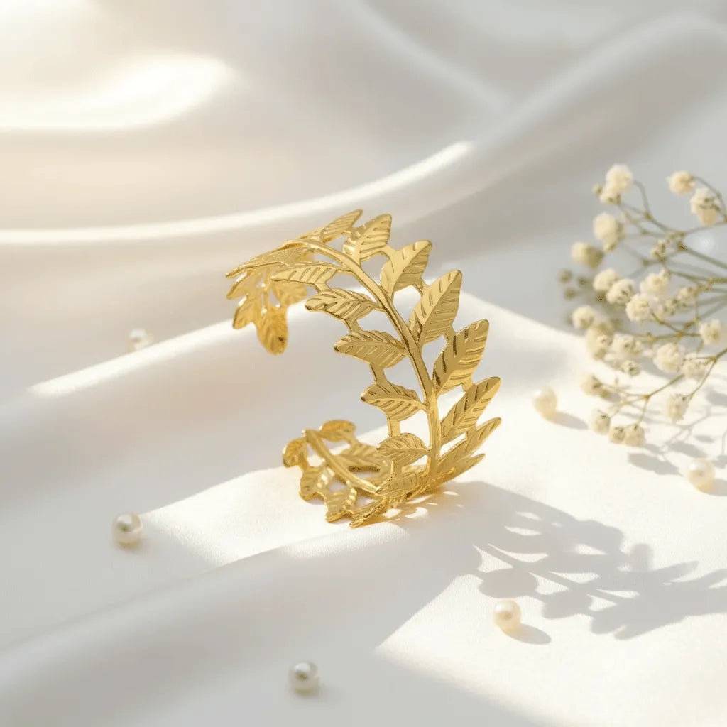 The adjustable Golden Leaf Cuff Bracelet with detailed leaf patterns and a premium gold finish adds a stylish touch to both traditional and western outfits. 