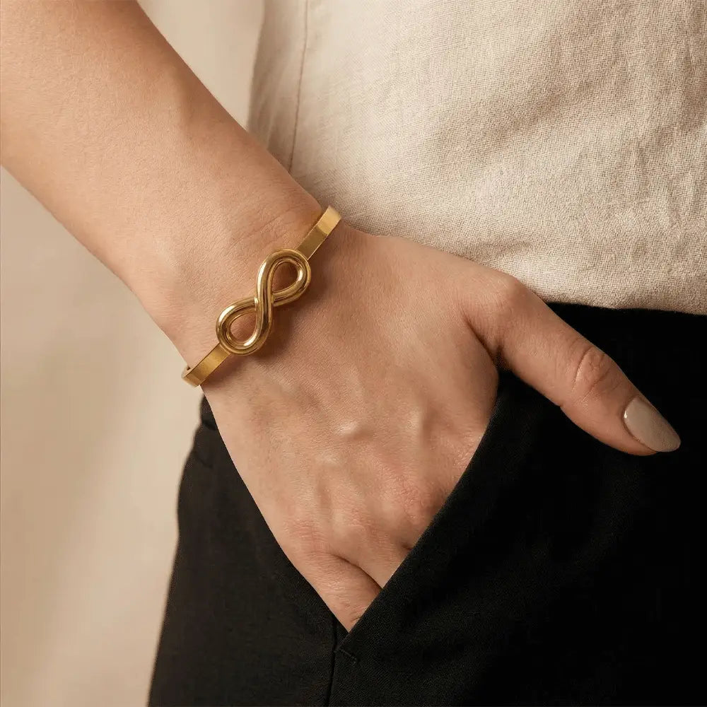 Woman wearing gold infinity bracelet, minimal anti-tarnish kada bracelet for daily wear, stylish gold jewellry