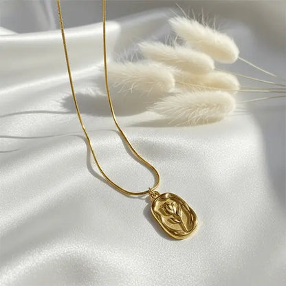Gold Serenity Pendant necklace on white satin fabric with soft sunlight and dried pampas grass – minimal luxury jewellery