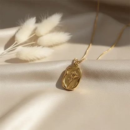 Gold Serenity Pendant close-up featuring elegant oval pendant on smooth satin background with warm natural light