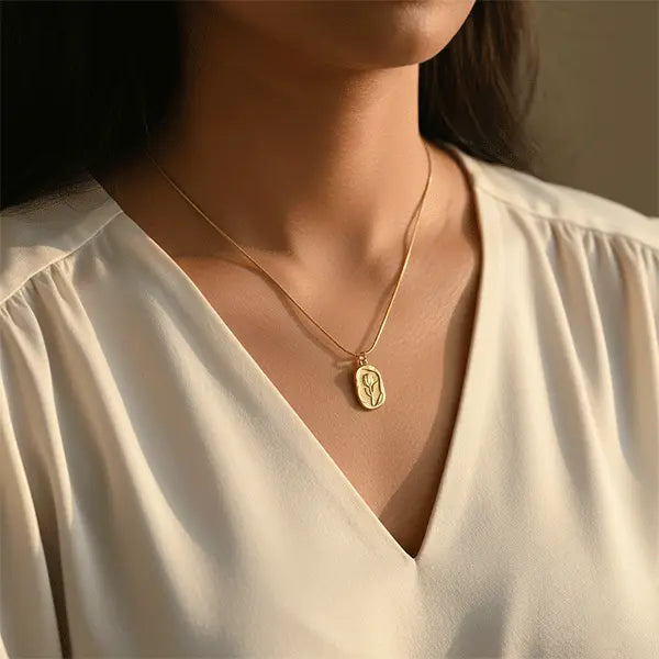 Gold Serenity Pendant worn by model, delicate gold necklace styled with ivory outfit for an elegant everyday look
