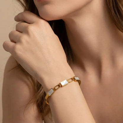Woman wearing luxury gold anti-tarnish bracelet with modern geometric design and crystal embellishments by K-A Trends