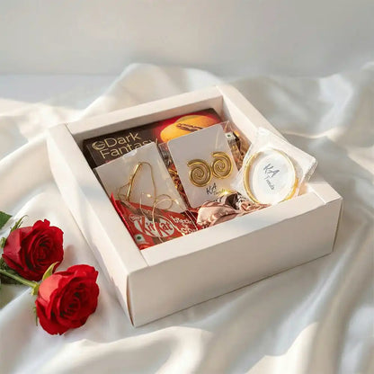 Golden Statement Valentine hamper featuring anti-tarnish gold-tone spiral earrings, statement bracelet, chocolates, and fairy lights, beautifully arranged in a white gift box with red roses.