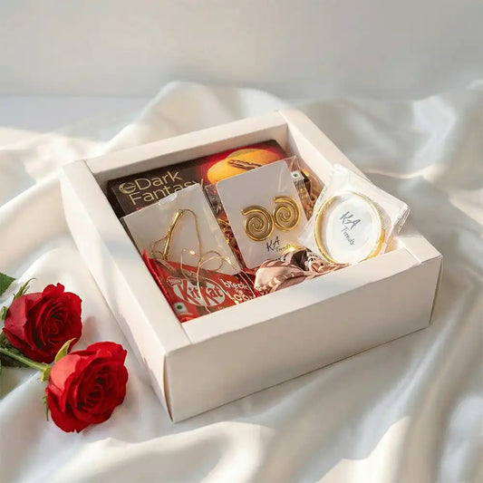Golden Statement Valentine hamper featuring anti-tarnish gold-tone spiral earrings, statement bracelet, chocolates, and fairy lights, beautifully arranged in a white gift box with red roses.