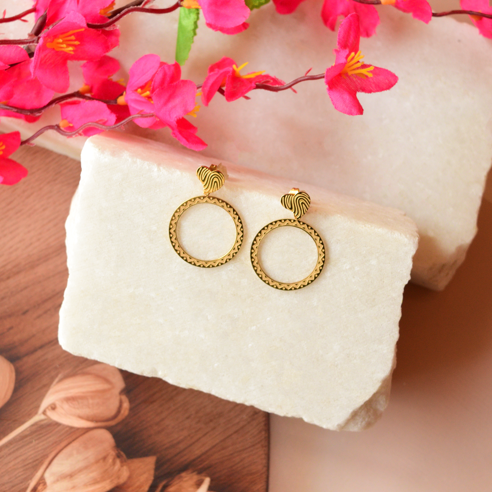 Golden Aura Hoops glow with a smooth, radiant finish.