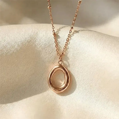 Halo Pendant anti-tarnish oval pendant necklace displayed on smooth satin surface with minimal luxury styling