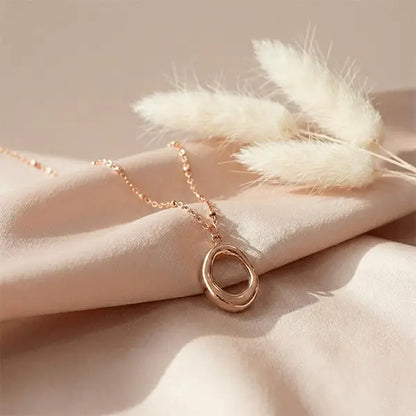 Halo Pendant anti-tarnish oval necklace placed on soft satin fabric with dried pampas grass and warm natural light