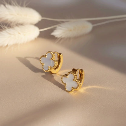 Ivory Clover Hoops earrings with mother-of-pearl clover design placed on beige satin fabric with soft sunlight and pampas grass