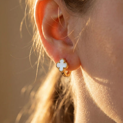 Close-up of Ivory Clover Hoops earring highlighting clover shape and smooth white inlay in warm sunlight