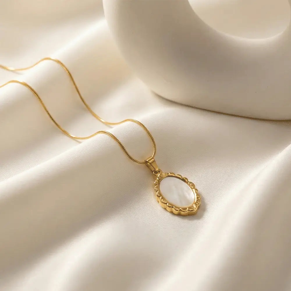 Ivory frame pendant necklace with white stone and gold border on satin background, anti tarnish pendant by K-A Trends