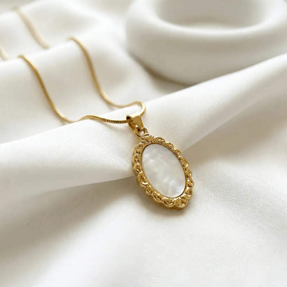 Close up of ivory frame oval pendant in gold finish, anti tarnish minimalist necklace for women