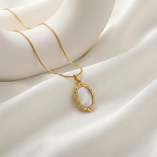 Gold ivory frame pendant necklace on soft white fabric, lightweight anti tarnish necklace for daily wear