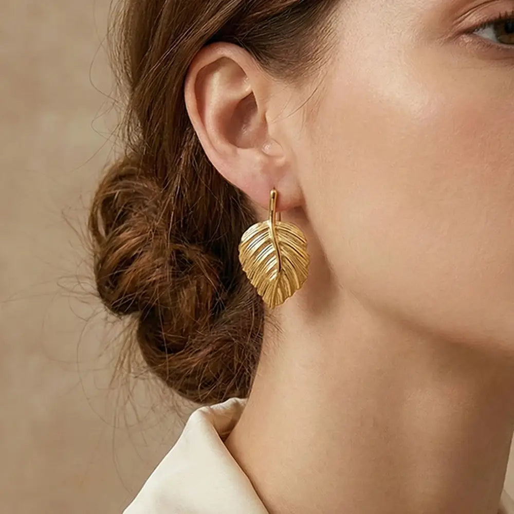 K-A Trends anti tarnish gold leaf stud earrings worn by female model close up elegant jewellery styling