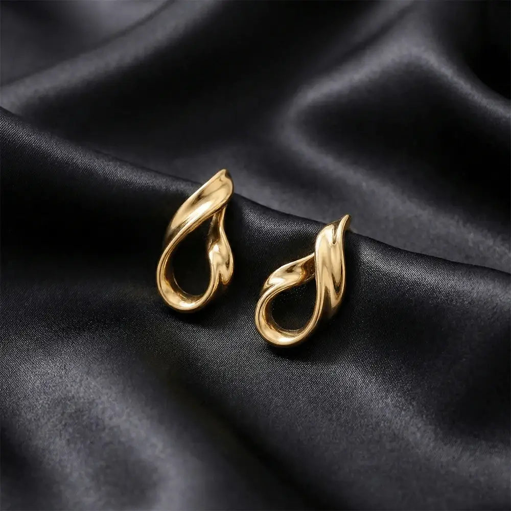 Close up of liquid gold stud earrings on black satin background, anti tarnish gold plated minimalist earrings for women
