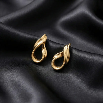 Close up of liquid gold stud earrings on black satin background, anti tarnish gold plated minimalist earrings for women