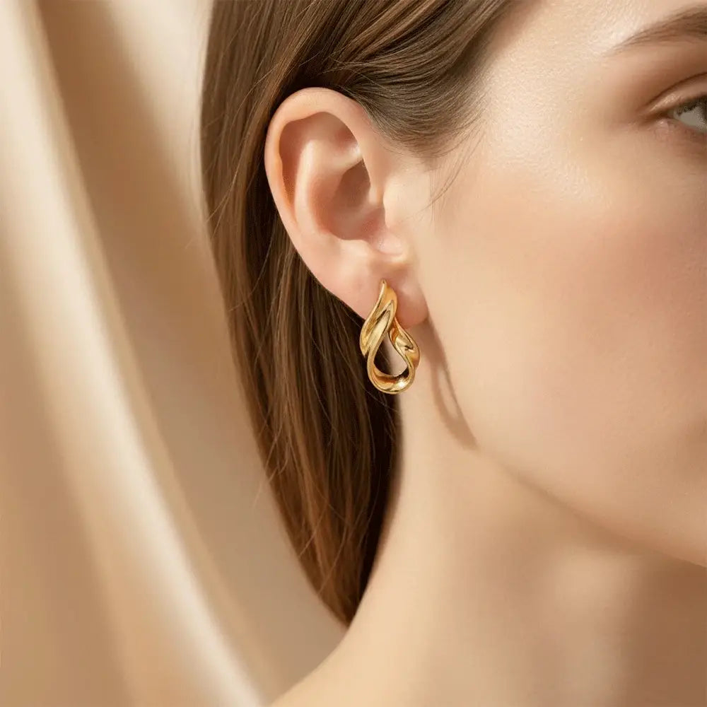 Model wearing liquid gold stud earrings in polished gold finish, modern anti tarnish everyday earrings by K-A Trends