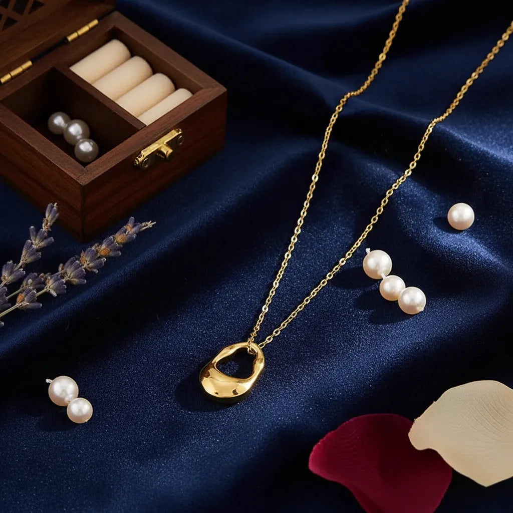 Dainty gold-plated necklace featuring a textured, irregular, molten metal pendant.