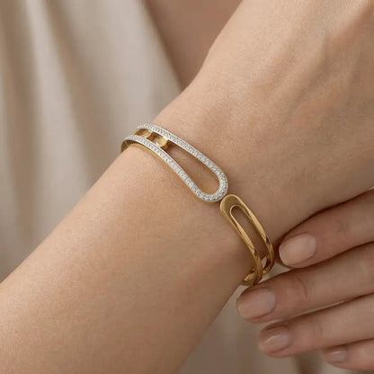 Loop crystal gold bracelet worn on wrist, featuring sleek open loop design with pavé crystals.