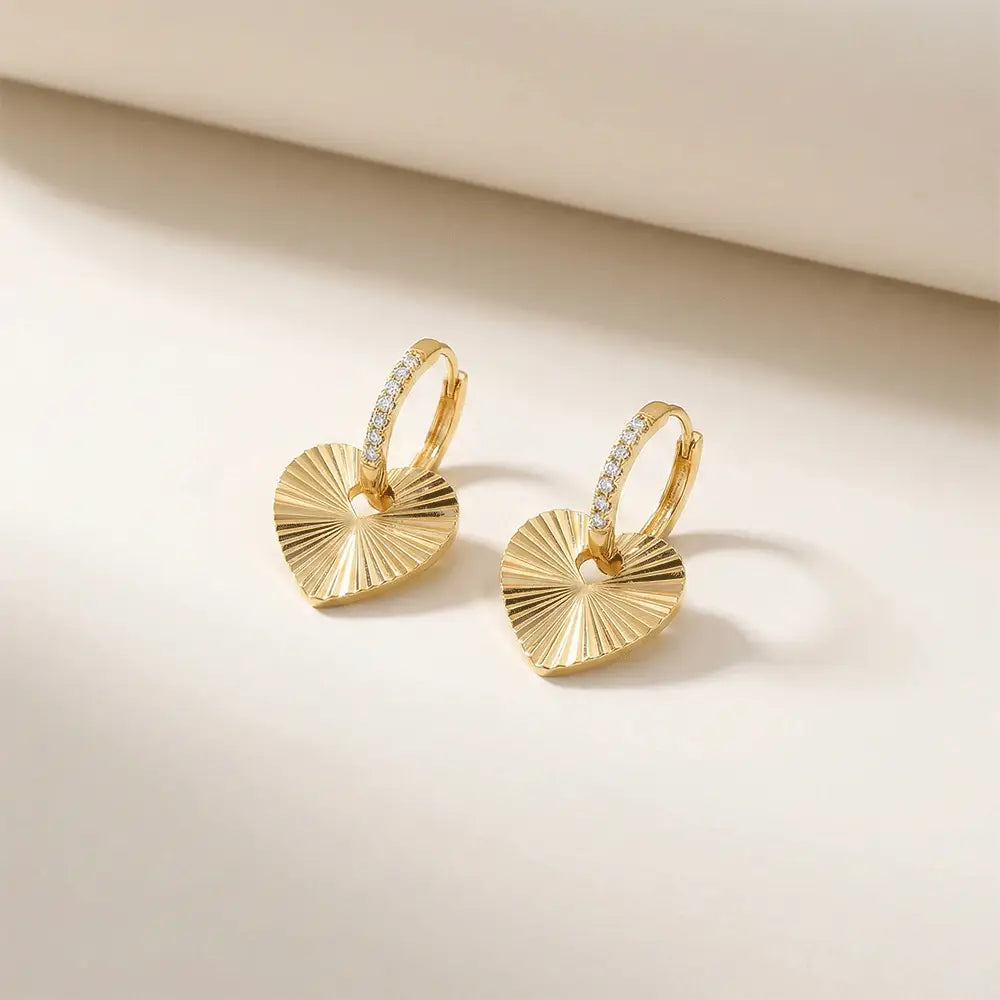 Gold heart hoop earrings with crystal detailing, anti tarnish love hoops on minimal beige background