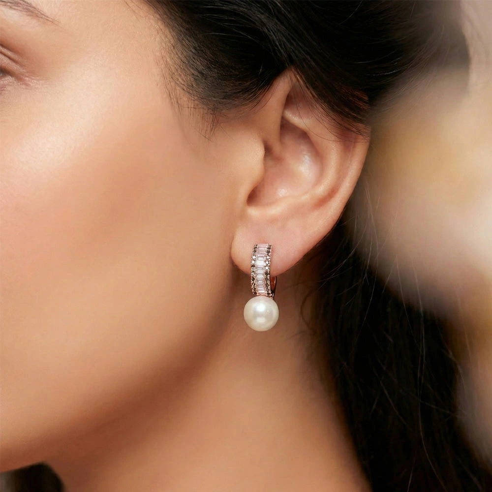 Model wearing Luxe Pearl Earrings – Anti-Tarnish rose gold hoops featuring a crystal row and pearl drop.