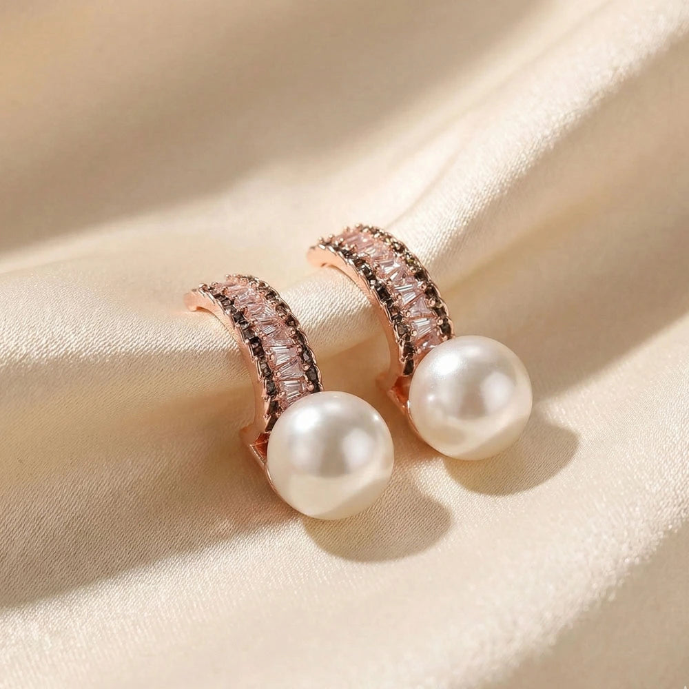 Luxe Pearl Earrings – Anti-Tarnish rose gold earrings with baguette crystals and a pearl drop on cream satin.