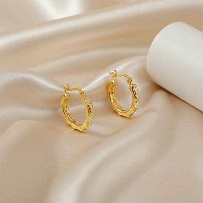 Gold melted texture hoop earrings on satin background, anti tarnish modern hoops for everyday wear
