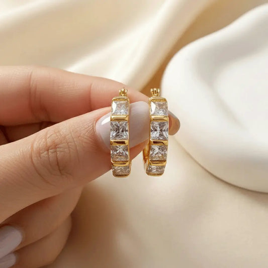 Close up of melted gold hoop earrings with crystal accents, anti tarnish lightweight hoops for women