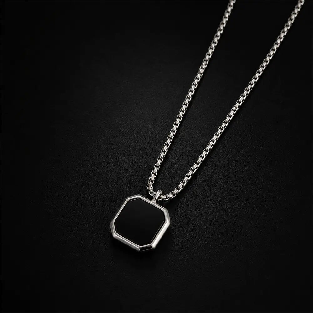 Luxury black geometric pendant necklace with silver stainless steel chain on dark premium background by K-A Trends