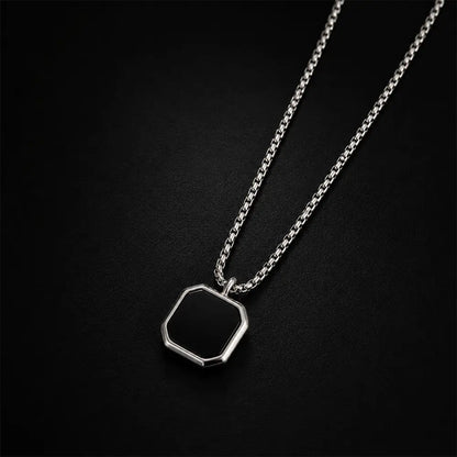 Luxury black geometric pendant necklace with silver stainless steel chain on dark premium background by K-A Trends