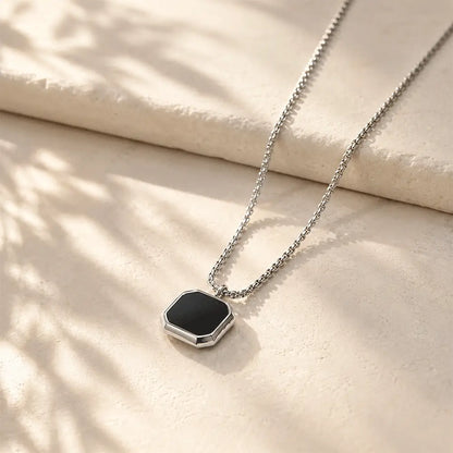 Premium black hexagon pendant necklace with stainless steel chain on elegant beige background by K-A Trends